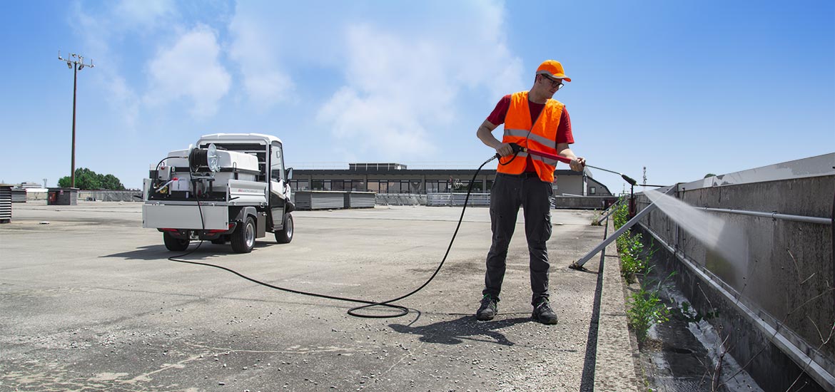 Utility vehicle with pressure washer for urban maintenance